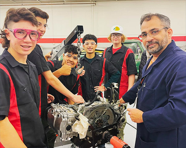 SECTA students and teacher with car engine